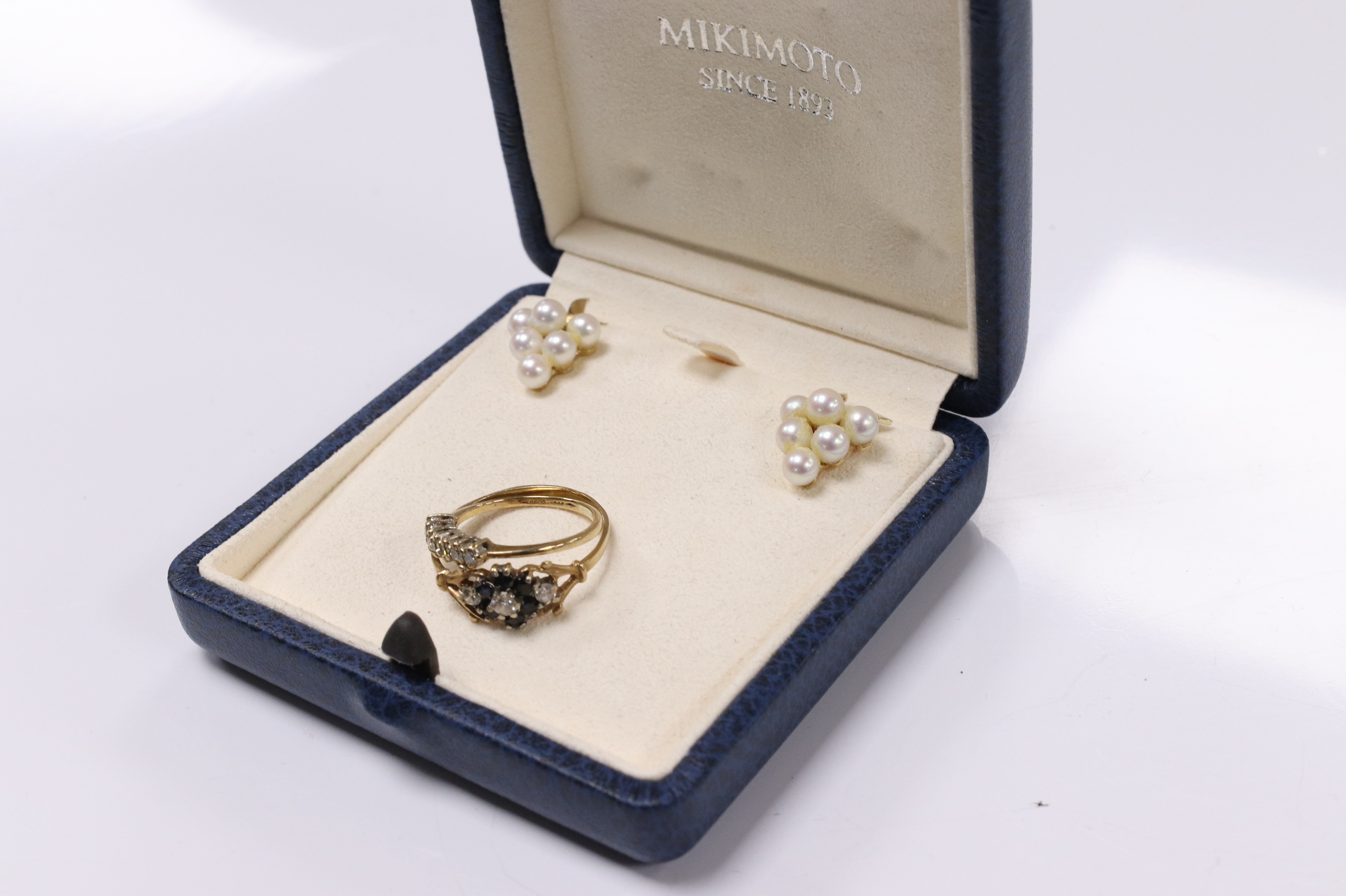 A modern pair of 375 and cluster pearl cluster set earrings, 17mm, in a Mikimoto box, (earrings not signed), together with two modern 9ct gold and gem set rings. Condition - fair